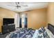 Bedroom with neutral walls, ceiling fan, and dark wood flooring at 10129 Paddock Oaks Dr, Riverview, FL 33569