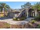 Charming single-story home featuring a three-car garage, brick driveway, and landscaped front yard at 10129 Paddock Oaks Dr, Riverview, FL 33569
