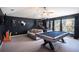 Large game room with a pool table and basketball game near the windows at 10129 Paddock Oaks Dr, Riverview, FL 33569