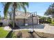 A three-car garage with brick paver driveway and basketball hoop at 10129 Paddock Oaks Dr, Riverview, FL 33569
