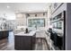 Modern kitchen features white cabinetry, a center island, stainless steel appliances, and a large window at 10129 Paddock Oaks Dr, Riverview, FL 33569