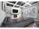 Inviting living room showcasing coffered ceilings, stone fireplace, built-in shelves, and large windows at 10129 Paddock Oaks Dr, Riverview, FL 33569