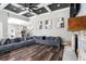 Open living room featuring dark wood floors, a stone fireplace, and seamless flow into the kitchen at 10129 Paddock Oaks Dr, Riverview, FL 33569