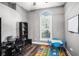 Dedicated office area featuring dark wood floors, a large window, and versatile furniture at 10129 Paddock Oaks Dr, Riverview, FL 33569