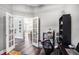 Versatile office space with French doors, dark wood floors, and ample natural light at 10129 Paddock Oaks Dr, Riverview, FL 33569