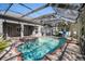 Beautiful screened pool area with a hot tub, pool, and a basketball hoop at 10129 Paddock Oaks Dr, Riverview, FL 33569