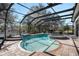 Outdoor view of a lovely screened in pool with a hot tub and a basketball hoop at 10129 Paddock Oaks Dr, Riverview, FL 33569