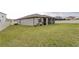 Spacious backyard with a screened lanai and a well-maintained lawn, surrounded by a white fence at 10812 Applewood Range Way, Tampa, FL 33647