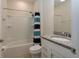 Clean bathroom with a shower-tub combo, vanity, and granite countertop at 10812 Applewood Range Way, Tampa, FL 33647