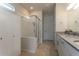 Modern bathroom showcasing a glass shower, granite countertop, and white cabinetry at 10812 Applewood Range Way, Tampa, FL 33647