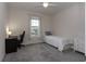 Bedroom with a ceiling fan, large window, and carpeted floors at 10812 Applewood Range Way, Tampa, FL 33647