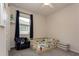 Cozy ' room with a toddler bed and a chair, illuminated by natural light at 10812 Applewood Range Way, Tampa, FL 33647