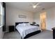 Bright bedroom with a ceiling fan, plush carpet, and ensuite bathroom access at 10812 Applewood Range Way, Tampa, FL 33647