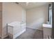 Neutral Bedroom with a white crib, carpeted floor, and a natural light from a window at 10812 Applewood Range Way, Tampa, FL 33647