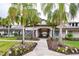 Inviting clubhouse entrance framed by palm trees and lush landscaping at 10812 Applewood Range Way, Tampa, FL 33647