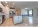 Open kitchen with a center island, modern appliances, and seamless integration with the living space at 10812 Applewood Range Way, Tampa, FL 33647