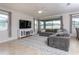 Cozy living room showcasing modern décor, ample natural light, and an entertainment center at 10812 Applewood Range Way, Tampa, FL 33647