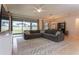 Open living room featuring a large sectional sofa, access to the backyard and neutral color palette at 10812 Applewood Range Way, Tampa, FL 33647