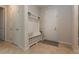 Bright mud room area featuring a built-in bench and storage, with a neutral color palette at 10812 Applewood Range Way, Tampa, FL 33647