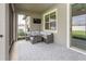 Enclosed patio space with comfortable seating area and outdoor TV for entertaining at 10812 Applewood Range Way, Tampa, FL 33647