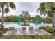 Resort-style pool with lounge chairs, sun umbrellas, and palm trees at 10812 Applewood Range Way, Tampa, FL 33647