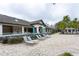 Clubhouse pool deck with ample seating and umbrellas, framed by mature landscaping at 10812 Applewood Range Way, Tampa, FL 33647