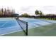Well-maintained tennis courts with a covered seating area and professional nets at 10812 Applewood Range Way, Tampa, FL 33647