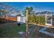 Spacious backyard features an outdoor shower, utility shed, and enclosed pool area, offering both functionality and leisure at 11077 87Th Ave, Seminole, FL 33772