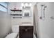 Clean bathroom with white tiled shower, dark vanity, and decorative shelving at 11077 87Th Ave, Seminole, FL 33772