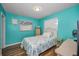A sunlit bedroom is decorated in a coastal style with light colors and wood floors at 11077 87Th Ave, Seminole, FL 33772