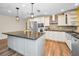 Bright kitchen featuring a center island, stainless steel appliances, granite countertops, and modern pendant lighting at 11077 87Th Ave, Seminole, FL 33772