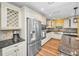 Spacious kitchen with stainless steel appliances, a large island, and custom wine rack above the built-in refrigerator at 11077 87Th Ave, Seminole, FL 33772