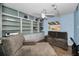 Comfortable living room with a large built-in bookcase, ceiling fan, and lots of natural light at 11077 87Th Ave, Seminole, FL 33772