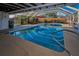 A screened in pool area has a covered deck, a patio table and chairs, and a privacy fence at 11077 87Th Ave, Seminole, FL 33772