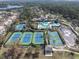 Community aerial view showcasing the pool, clubhouse, basketball and tennis courts, and well-maintained landscaping at 11620 Bristol Chase Dr, Tampa, FL 33626
