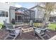 Landscaped backyard featuring a fire pit with seating, creating a cozy outdoor retreat at 11620 Bristol Chase Dr, Tampa, FL 33626