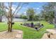 Spacious backyard featuring a fire pit with Adirondack chairs, perfect for outdoor gatherings at 11620 Bristol Chase Dr, Tampa, FL 33626