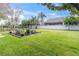 Large backyard featuring a fire pit with seating, ideal for relaxing and entertaining at 11620 Bristol Chase Dr, Tampa, FL 33626