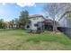 A spacious backyard with lush green grass, an outdoor firepit, and a screened-in patio for relaxing and entertaining at 11620 Bristol Chase Dr, Tampa, FL 33626