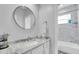 Well-lit bathroom featuring a marble countertop, modern fixtures, and a separate shower at 11620 Bristol Chase Dr, Tampa, FL 33626