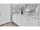 Bathroom vanity with dual sinks, marble countertops, and white cabinetry at 11620 Bristol Chase Dr, Tampa, FL 33626