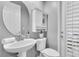 Half bath features a pedestal sink, round mirror, and a medicine cabinet at 11620 Bristol Chase Dr, Tampa, FL 33626