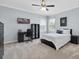 Well-lit bedroom with a ceiling fan, a desk, and neutral-colored walls at 11620 Bristol Chase Dr, Tampa, FL 33626