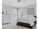 Bright bedroom with a black bed frame, a white comforter, and a view of the neighborhood at 11620 Bristol Chase Dr, Tampa, FL 33626