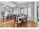 Elegant dining room features hardwood floors, plantation shutters and a decorative chandelier at 11620 Bristol Chase Dr, Tampa, FL 33626