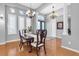 Elegant dining room with hardwood floors, chandeliers, and large windows for ample lighting at 11620 Bristol Chase Dr, Tampa, FL 33626