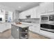 Well-equipped kitchen boasting stainless steel appliances, stone counters, and a center island at 11620 Bristol Chase Dr, Tampa, FL 33626