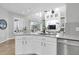 Bright kitchen features white cabinets, stainless steel appliances, and open layout to living area at 11620 Bristol Chase Dr, Tampa, FL 33626