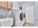 Well-organized laundry room with new appliances, sink, and plenty of storage space at 11620 Bristol Chase Dr, Tampa, FL 33626