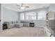 Spacious living area with neutral carpet, large windows, and a comfortable gray sectional at 11620 Bristol Chase Dr, Tampa, FL 33626